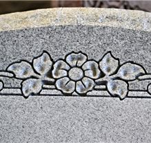 Sculpted floral bouquet carved into granite headstone