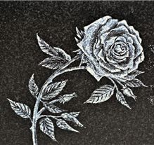 Sandblast carved cross design on dark granite memorial