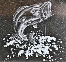 Leaping bass fish etching on granite headstone