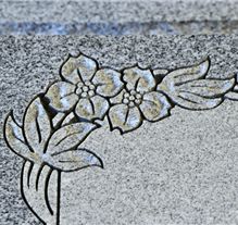 Block letter style with deep carving on gray granite