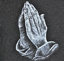 Old English style lettering carved on granite headstone