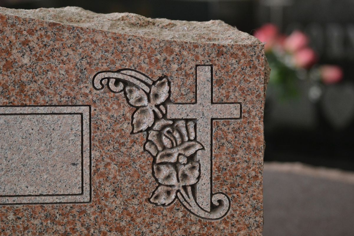 Granite headstone with detailed sandblast carving