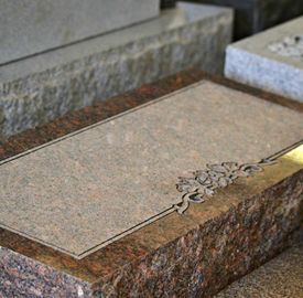 Granite bevel marker set flush in cemetery grounds