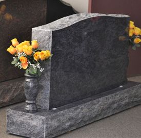 Polished granite upright monument with flowers at Chillicothe cemetery